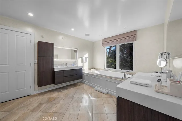 a bathroom with a sink double vanity and a bathtub