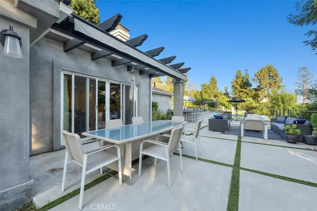 a view of a patio with a table and chairs and potted plants