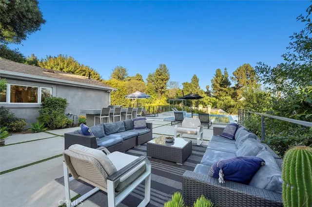 a view of a patio with couches under an umbrella