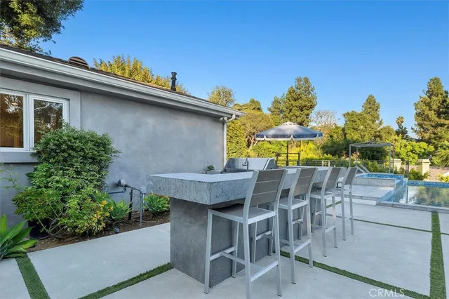 a view of a patio with table and chairs and potted plants