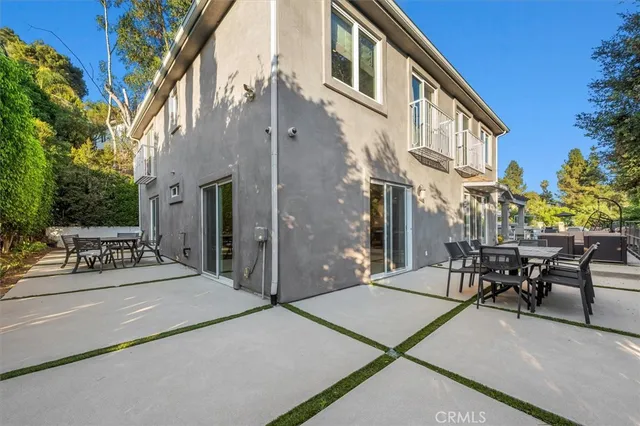 a view of a building with sitting area and furniture
