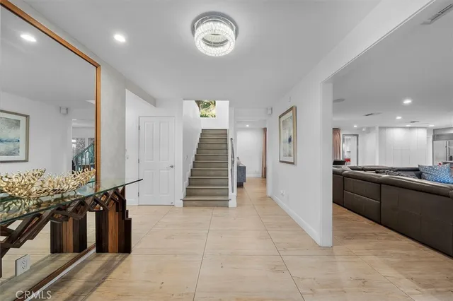 a view of a livingroom with wooden floor and stairs