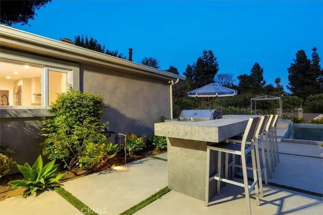 a view of a patio with table and chairs and potted plants