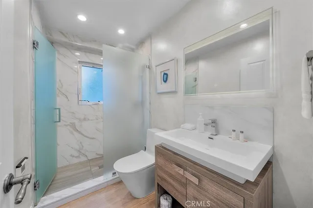 a bathroom with a sink toilet and shower
