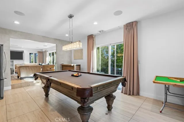 a room with pool table and windows