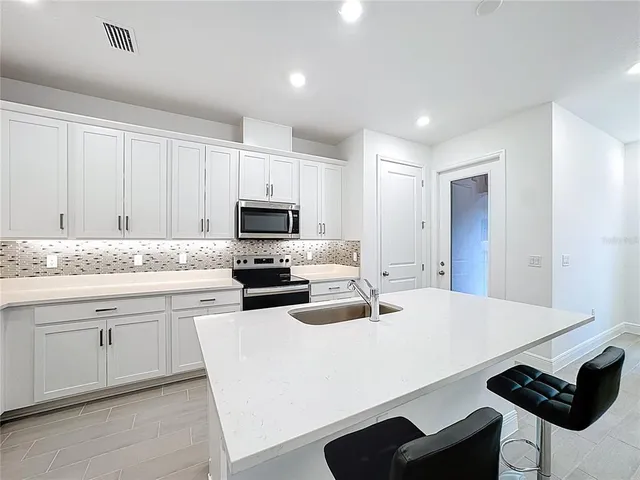 a kitchen with a sink and cabinets