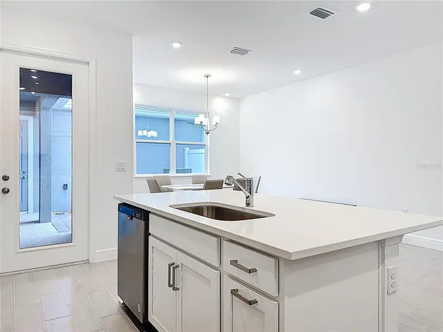 a view of a kitchen with white cabinets
