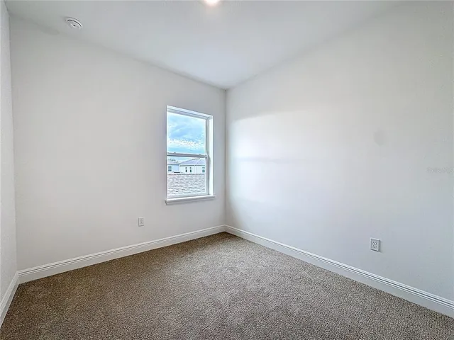 an empty room with closet and a bathroom