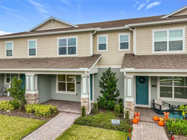 a front view of a house with a yard and outdoor seating