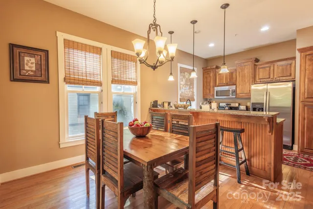 a dining room filled with furniture and a chandelier