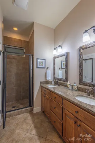 a spacious bathroom with a granite countertop sink mirror and shower
