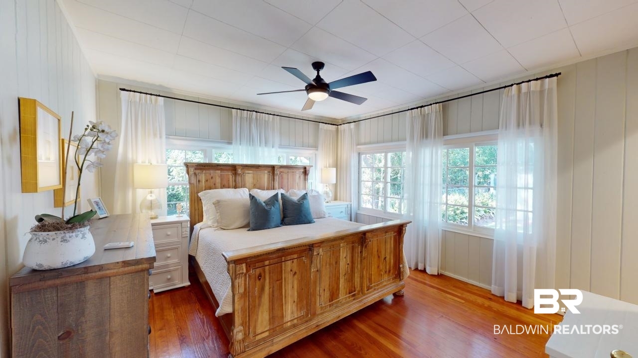 4358 Stein Street Mobile, AL 36608 - Photo 11 of 29 Bedroom featuring dark hardwood / wood-style flooring, ceiling fan, and wood walls