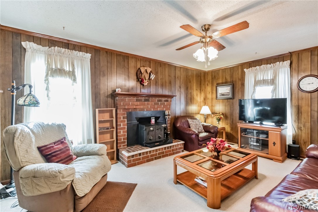 10411 Ambridge Road Chesterfield, VA 23832 - Photo 12 of 33 a living room with furniture a flat screen tv and a fireplace
