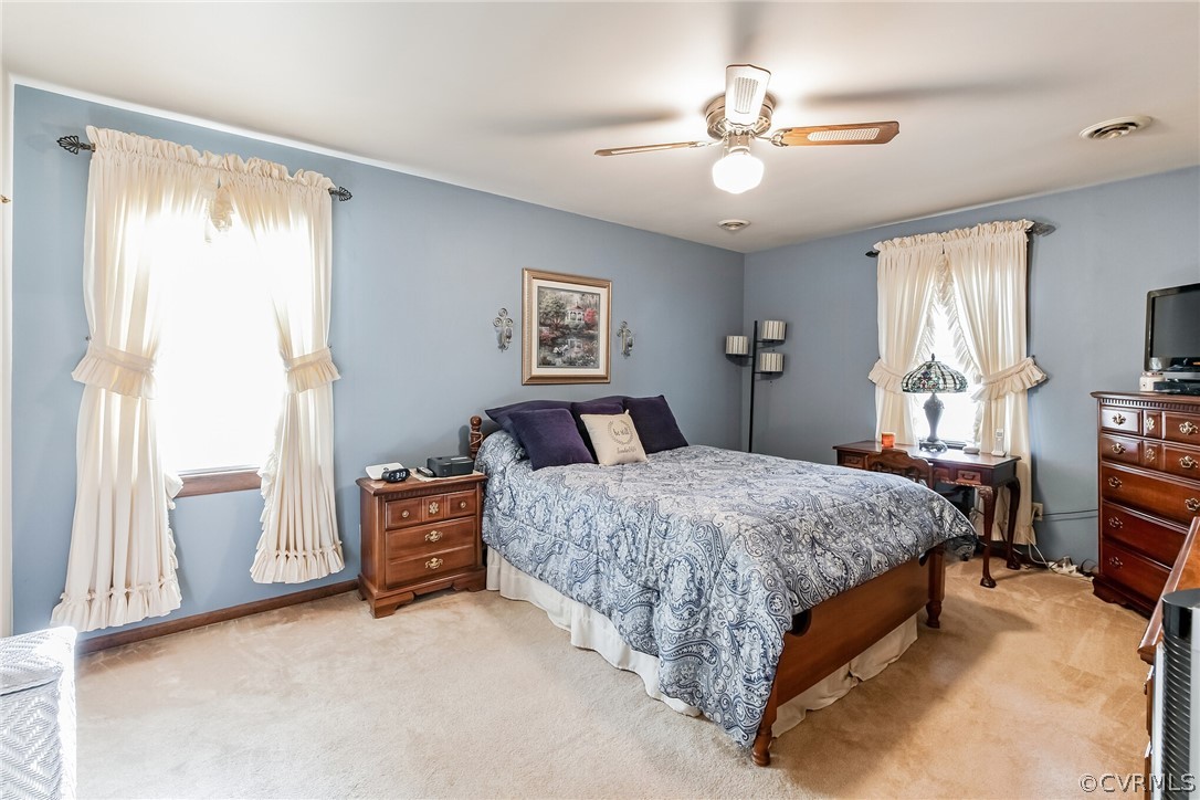 10411 Ambridge Road Chesterfield, VA 23832 - Photo 17 of 33 a bedroom with a large bed and a chandelier