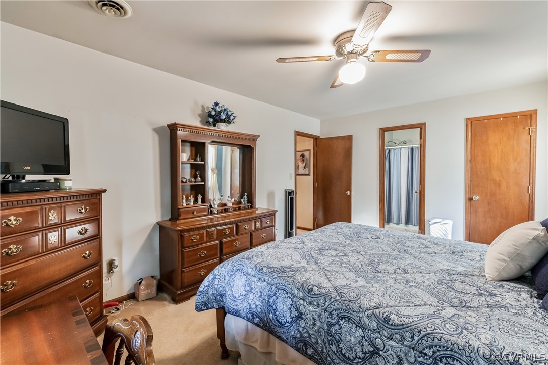 10411 Ambridge Road Chesterfield, VA 23832 - Photo 19 of 33 a bedroom with a bed and a flat tv screen on wall