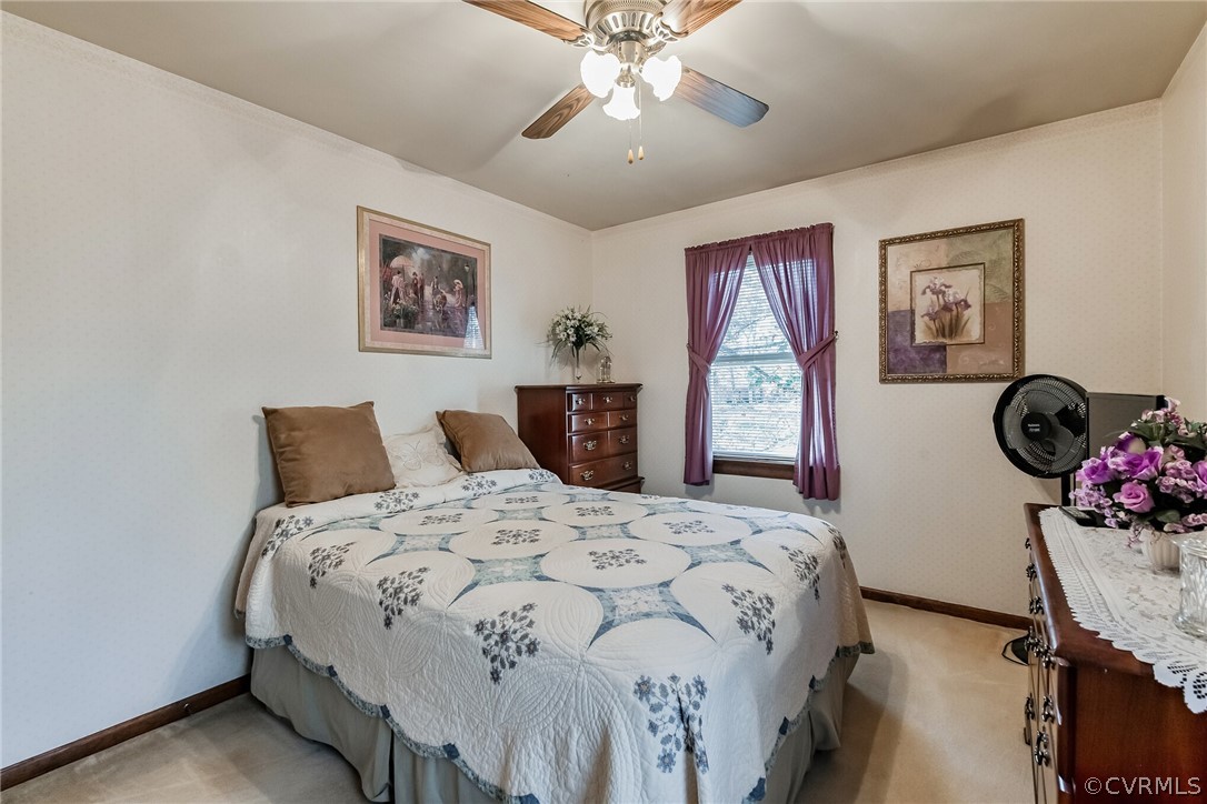 10411 Ambridge Road Chesterfield, VA 23832 - Photo 24 of 33 a bedroom with a bed and a chandelier