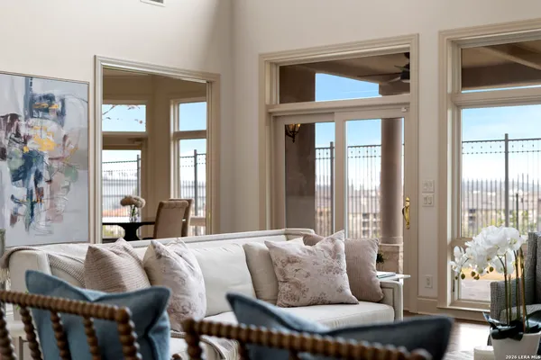 a living room with furniture and large windows