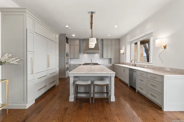 a kitchen with sink cabinets and wooden floor