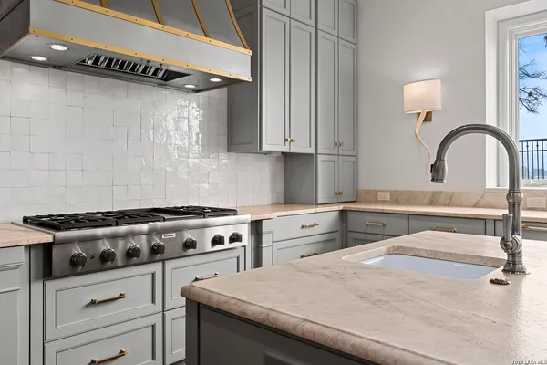 a kitchen with a stove and a white cabinets
