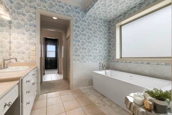 a spacious bathroom with a bathtub and sink