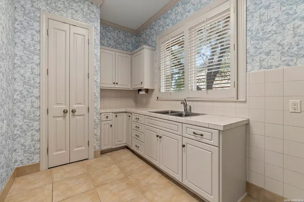 a view of a kitchen with sink and cabinets
