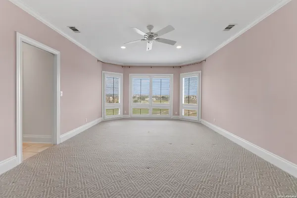 a view of an empty room with a ceiling fan