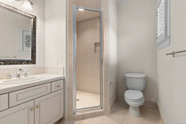 a bathroom with a toilet sink and shower