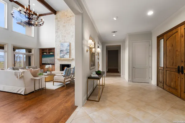 a living room with fireplace furniture and a chandelier