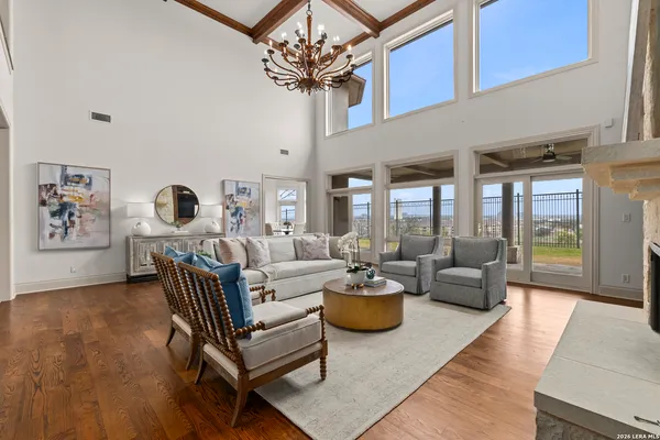 a living room with furniture and a chandelier