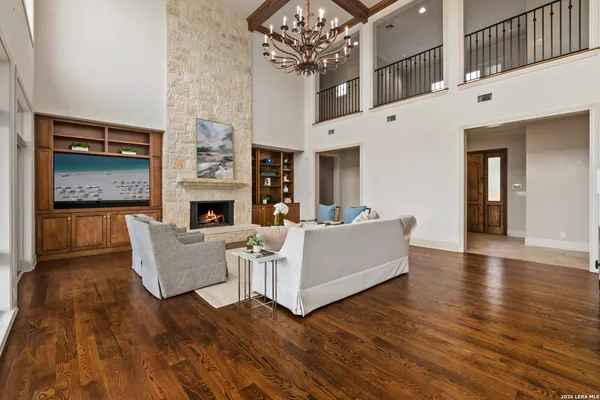 a living room with fireplace furniture and a chandelier