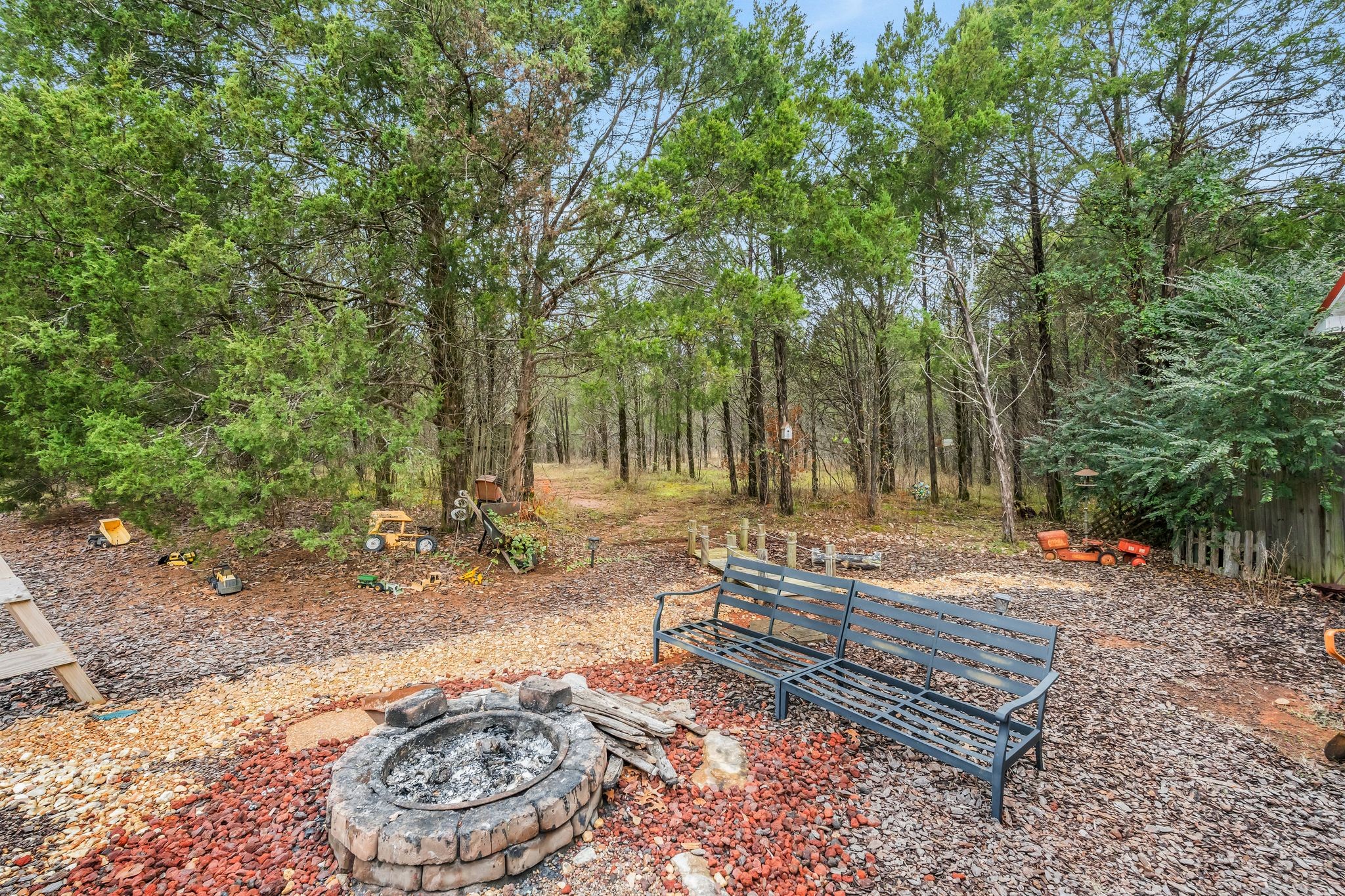 10955 Old Lebanon Road Murfreesboro, TN 37129 - Photo 75 of 100 a backyard of a house with trees and outdoor seating