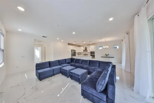 a living room with furniture and a mirror