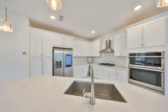 a kitchen with granite countertop a stove and a sink