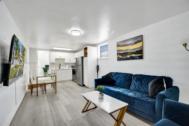 a living room with furniture and a floor to ceiling window