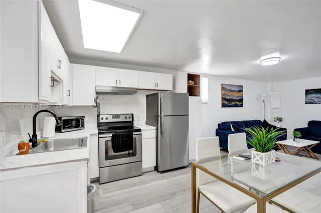 a bedroom with a bed and a large window with backyard view
