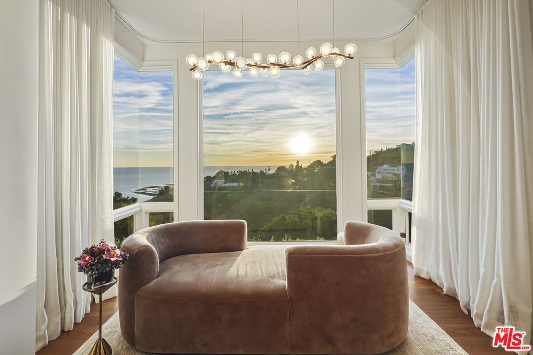 3140 Sweetwater Mesa Road Malibu, CA 90265 - Photo 40 of 71 a living room with furniture and a floor to ceiling window