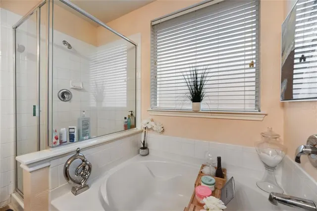 a bathroom with a tub sink and mirror