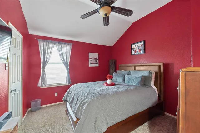 a bedroom with a bed and window