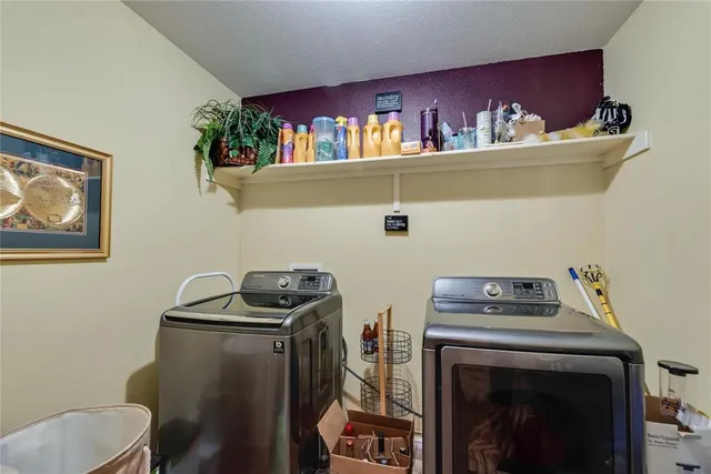 a kitchen with kitchen island granite countertop a sink cabinets and stainless steel appliances