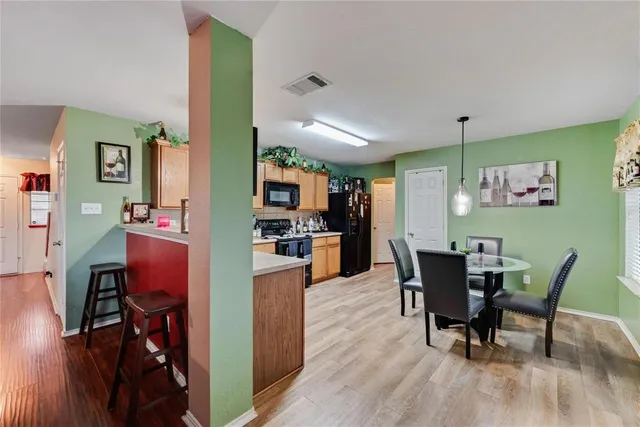 a view of a dining room with furniture and wooden floor