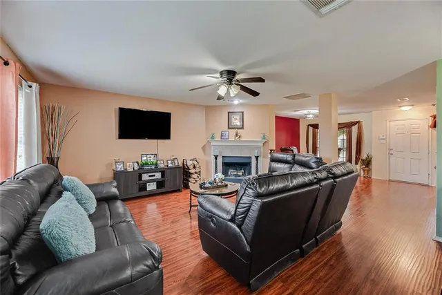 a living room with furniture a fireplace and a flat screen tv