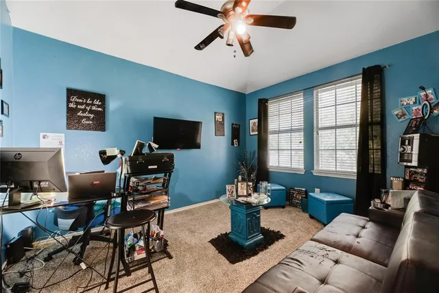 a living room with furniture a flat screen tv and a window