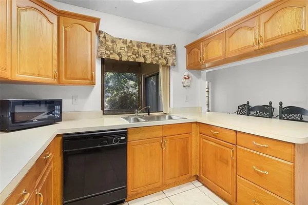 a kitchen with granite countertop stainless steel appliances a sink and cabinets