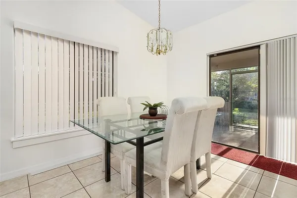 a view of a dining room with furniture and chandelier