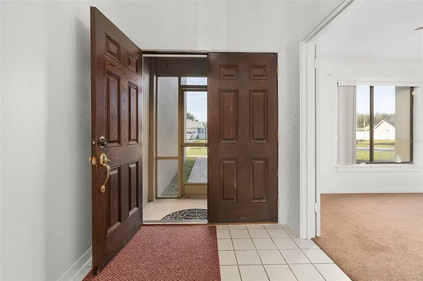 a view of a hallway with closet and a window