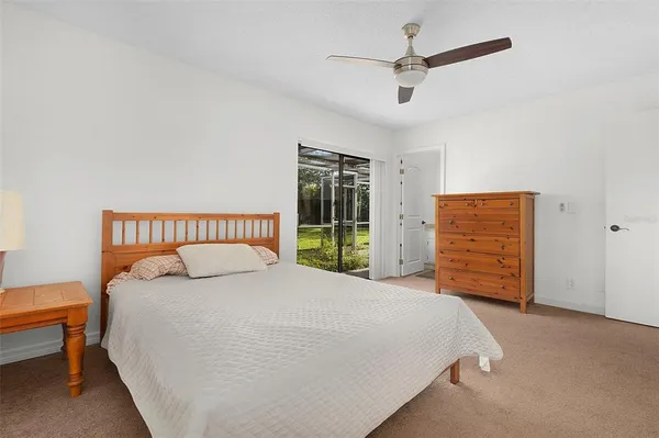 a large bed sitting in a bedroom next to a window and a dresser