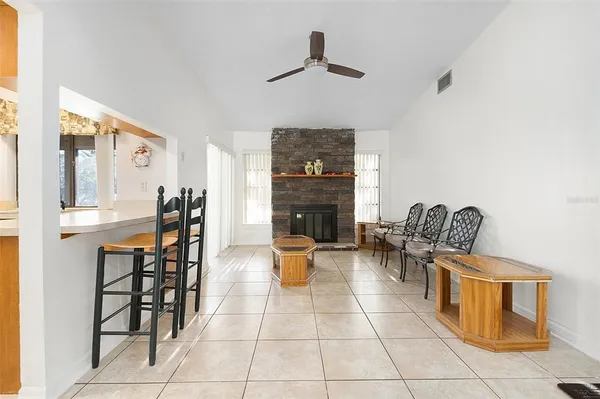a living room with furniture a dining table and chairs with wooden floor