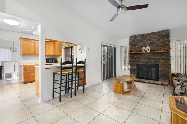 a living room with furniture a fireplace and a table