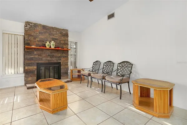 a living room with furniture a fireplace and a table