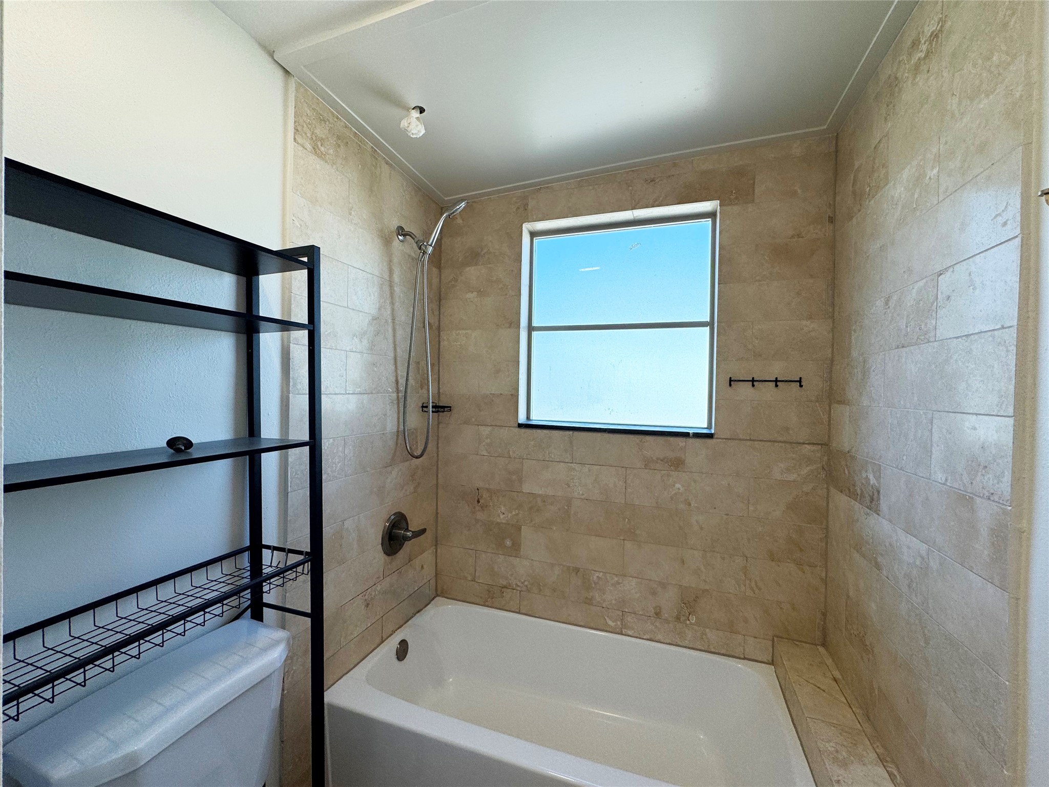 1509 Holman Street, Unit 2 Houston, TX 77004 - Photo 7 of 10 a bathroom with a bathtub and a shower